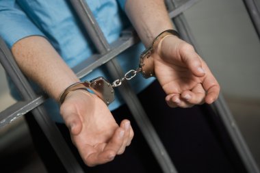 Criminal Handcuffed To Bars clipart