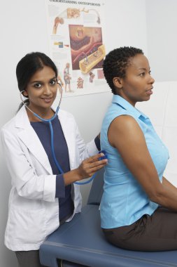 Female Doctor Doing A Medical Examination clipart