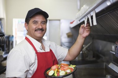 Man In Restaurant Kitchen clipart