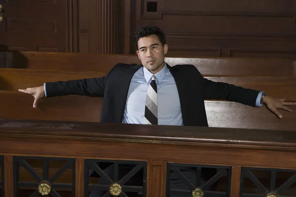 Thoughtful Male Lawyer Sitting In Courtroom — Stock Photo, Image