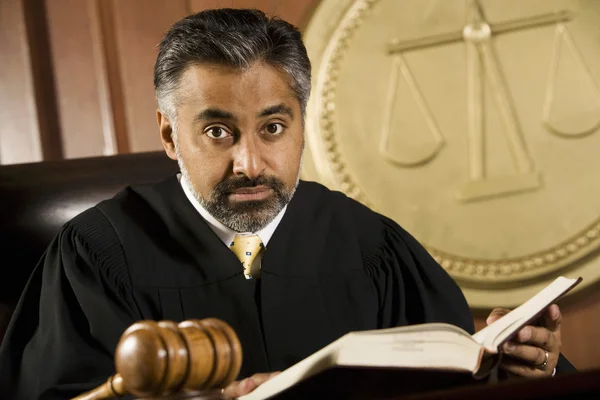 Rechter lezen van wet boek in de rechtszaal — Stockfoto