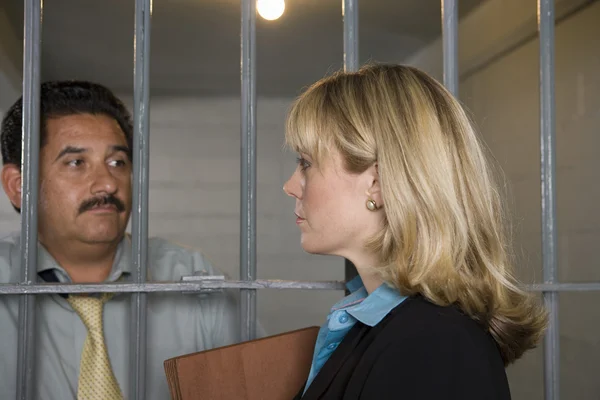 Lawyer With Criminal Behind Bars — Stock Photo, Image