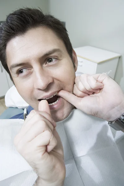 Dental Patient Flossing At Clinic — Stock Photo, Image