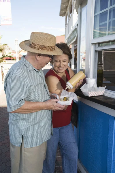 Senior Couple Eating Hot Dog — Stock Photo, Image
