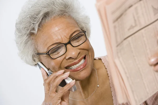 Cheerful Senior Woman Studying Stocks And Shares In Newspaper — Stock Photo, Image