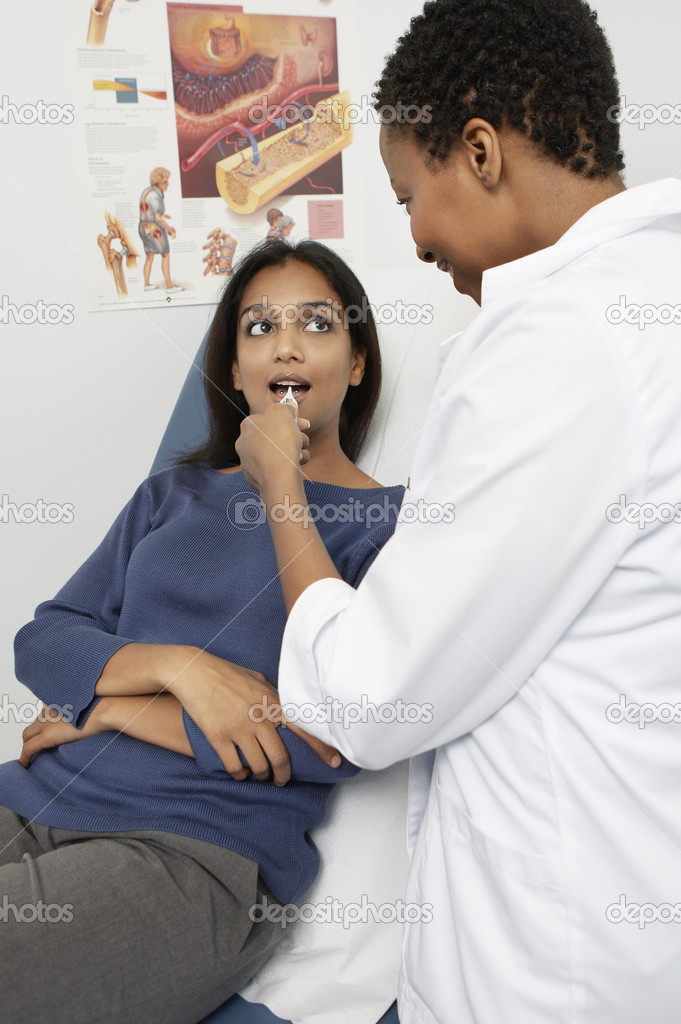 Female Doctor Examining Patient's Throat