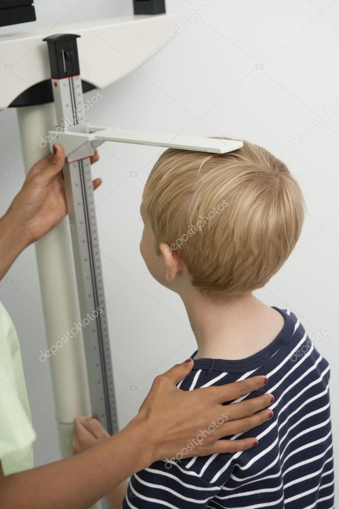 Nurse Measuring Boy's Height