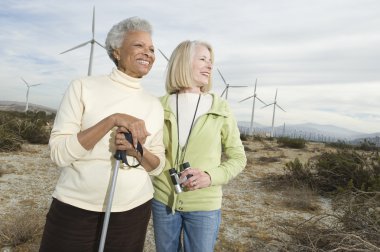 Women Hiking Near Wind Farm clipart