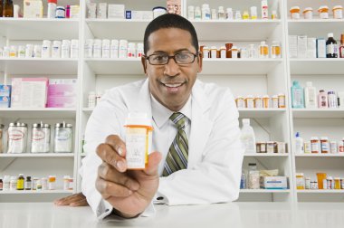 Male Pharmacist Working In Pharmacy clipart