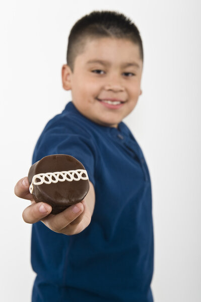 Preadolescent Boy Holding Cookie