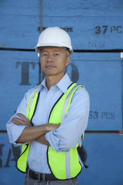 Portrait of a middle-aged warehouse worker standing with arms crossed — Stock Photo, Image