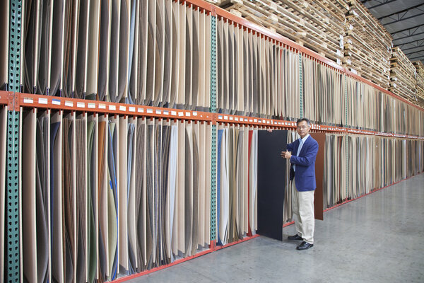 Manager holding plywood