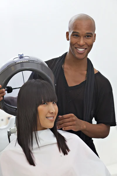 Asian woman getting herself groomed at hair salon — Stock Photo, Image