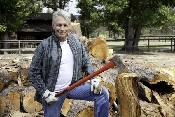 Portrait of senior lumber jack holding an axe — Stock Photo, Image