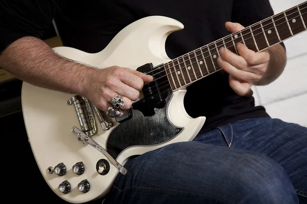 Close-up of mid adult man's torso playing guitar — Stock Photo, Image