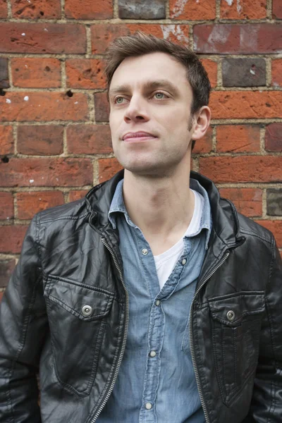 Handsome man in a leather jacket looking away — Stock Photo, Image