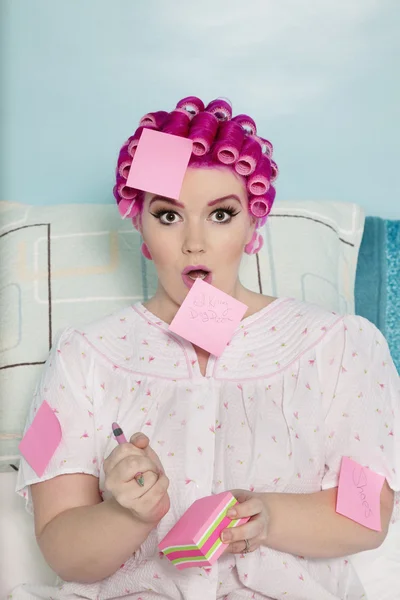 Portrait of shocked woman with sticky notes on herself — Stock Photo, Image