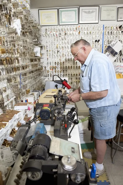 Senior locksmith  in hardware store — Stock Photo, Image