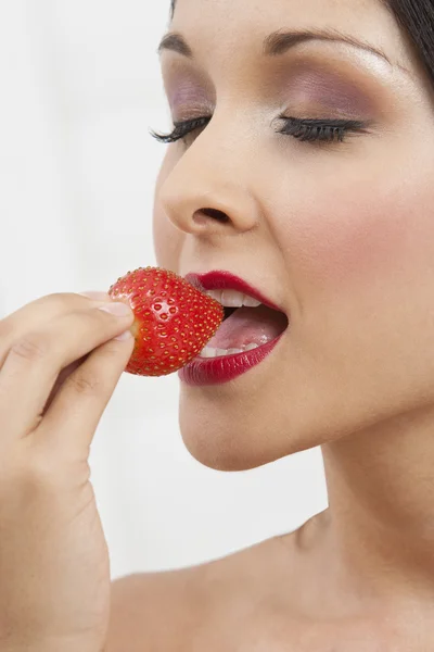 Seductive Woman Eating Strawberry Stock Image