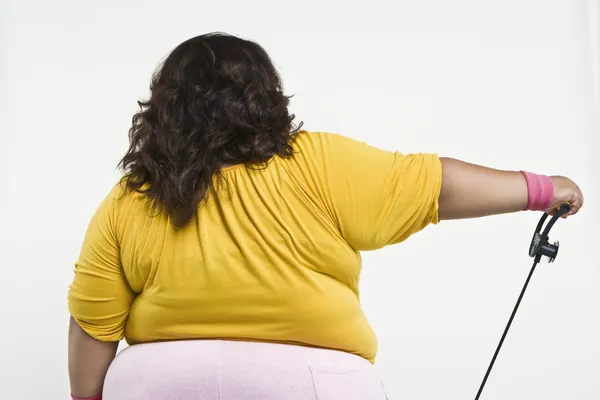 An Obese Woman Exercising - Stock Image. 