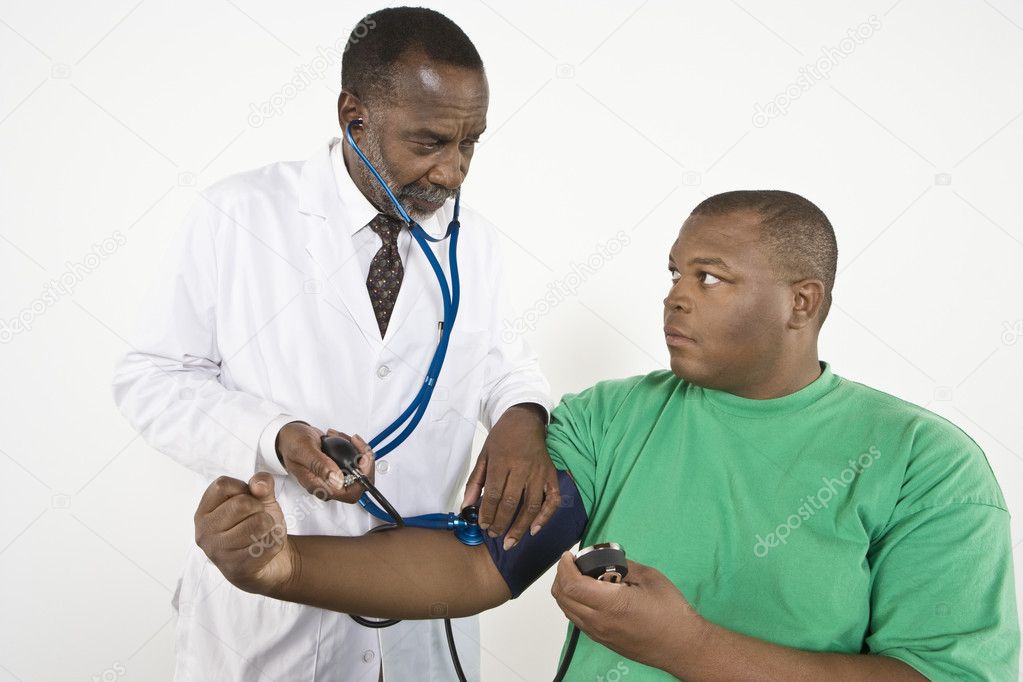 Doctor Checking Blood Pressure Of An Obese Patient