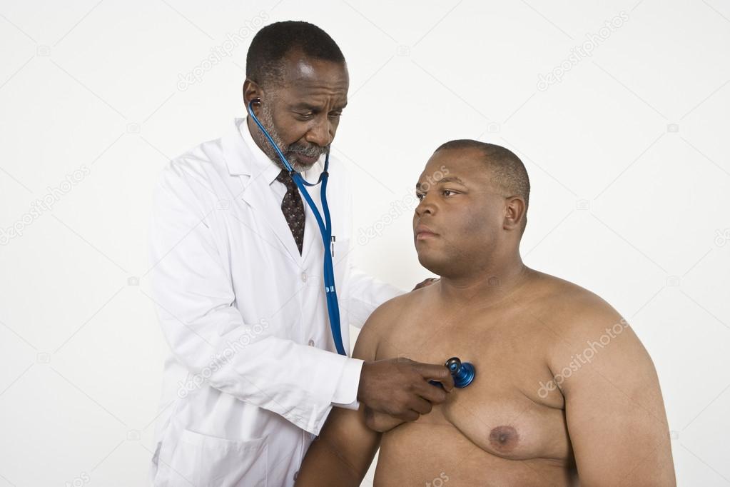 Doctor Checking An Obese Patient's Heartbeat