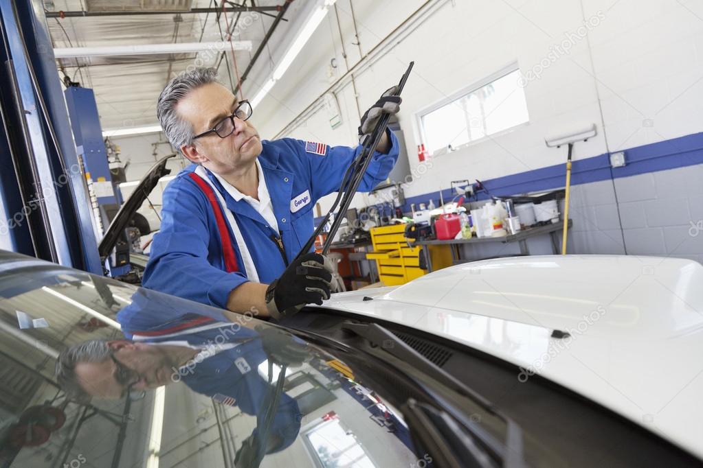 Senior mechanic working on windshield wipers