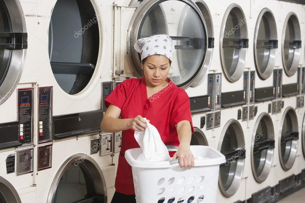 female employee carrying laundry basket