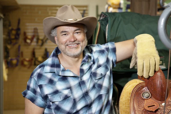 Portrait of a happy mature cowboy in feed store — Stock Photo, Image