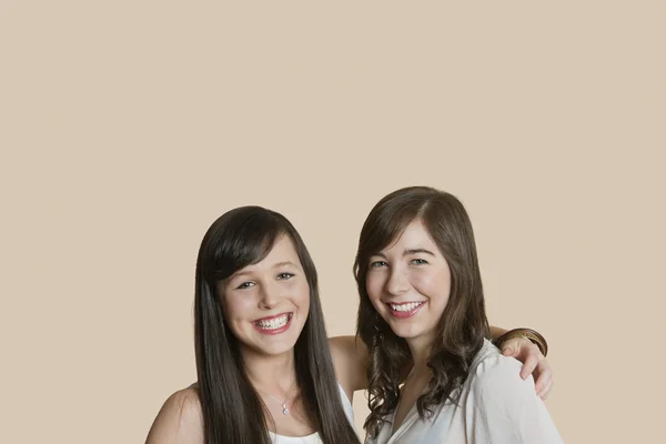 Portrait of young female friends over colored background — Stock Photo, Image