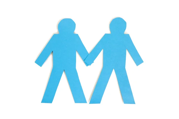 Two blue paper stick figures holding hands over white background — Stock Photo, Image
