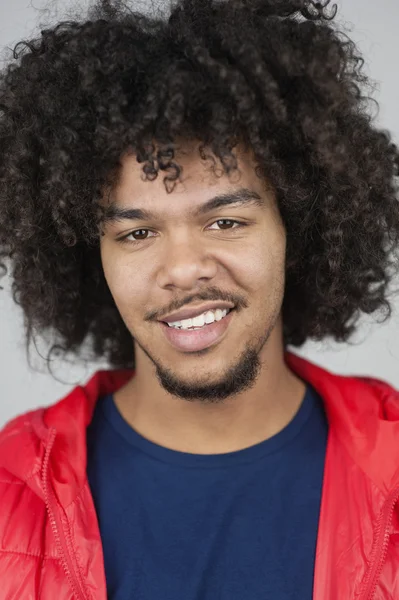 Portrait of happy young man with curly hair — Stock Photo, Image