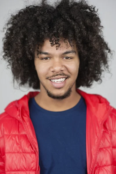 Portrait of a happy man with curly hair and goatee — Stock Photo, Image