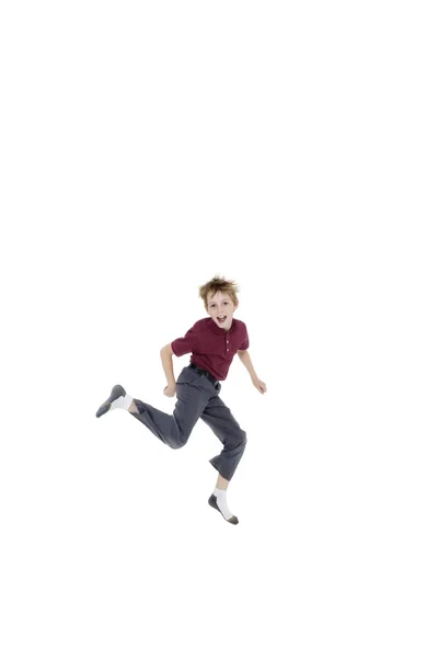 Retrato de alegre menino pré-adolescente pulando sobre fundo branco — Fotografia de Stock