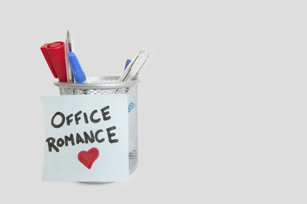 Conceptual image of sticky notepaper with heart shape depicting office romance — Stock Photo, Image