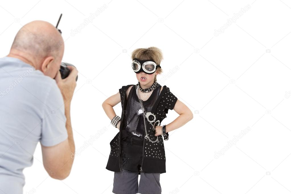 Senior adult photographer shooting punk kid over white background