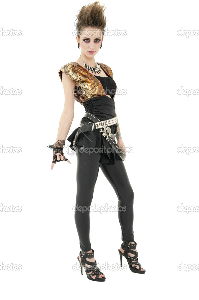 Portrait of punk woman with attitude gesturing rock & roll sign over white background