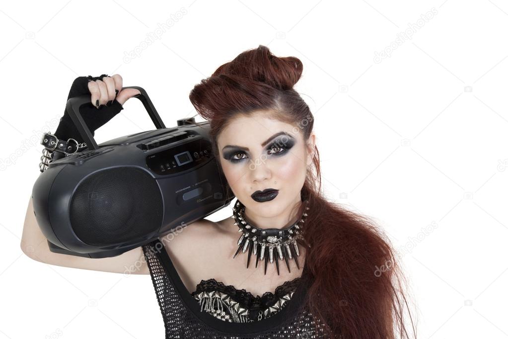 Portrait of punk woman holding boom box on shoulder over white background