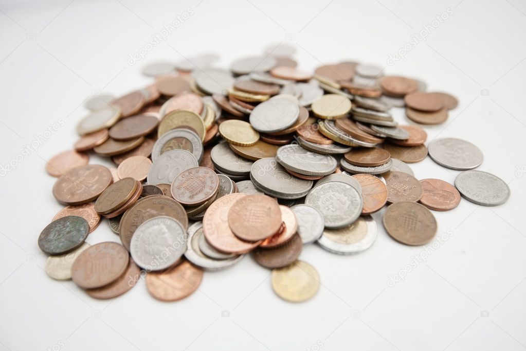 Close-up of large group of coins over white background