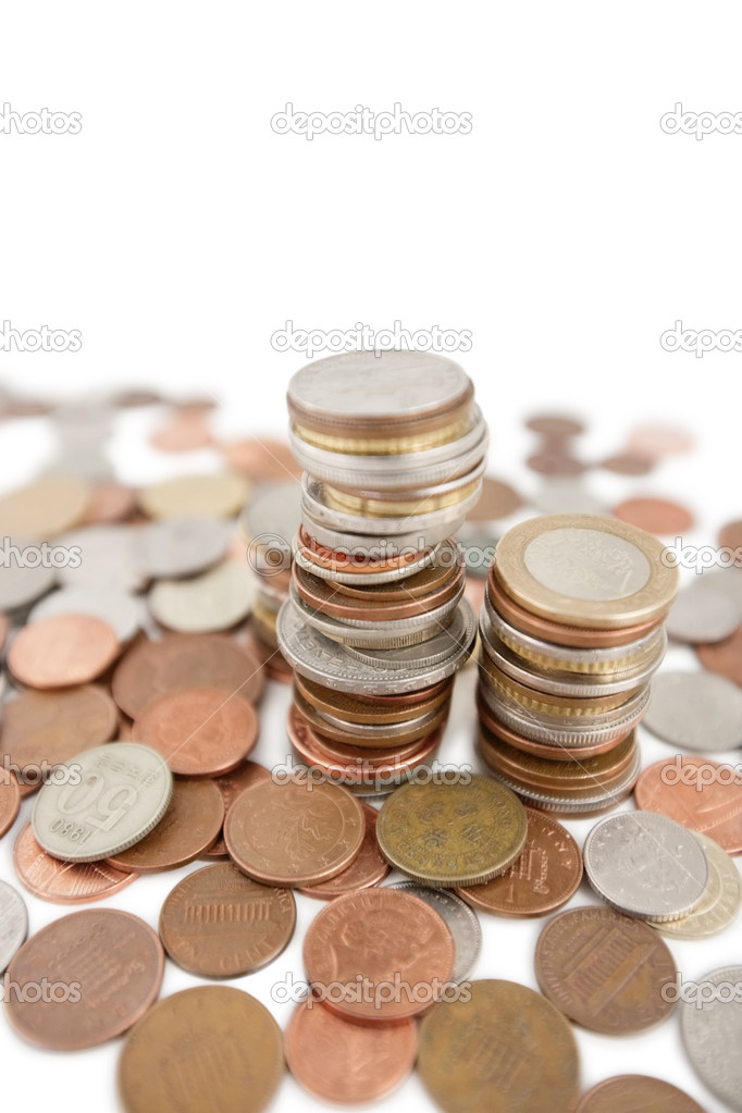 Close-up of heap of coins over white background