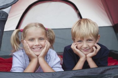 Brother And Sister Smiling From Tent