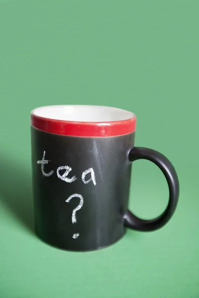 Close-up of coffee mug with text over colored background — Stock Photo, Image
