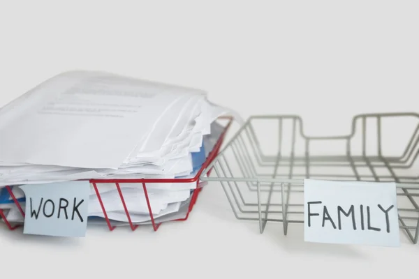 Pile of paperwork in work tray with empty family platter over white background — Stock Photo, Image