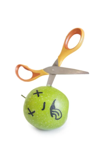 Granny smith apple murdered by scissor over white background — Stock Photo, Image