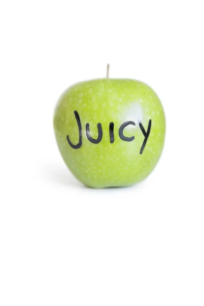 Close-up of orthographic text on a juicy granny smith apple over white background — Stock Photo, Image