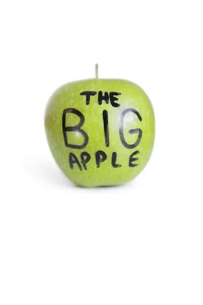 Close-up of text on a green apple over white background — Stock Photo, Image