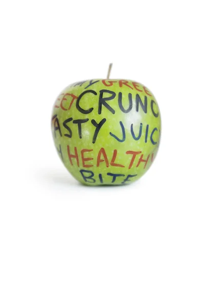 Gros plan d'une granny smith apple avec texte orthographique sur fond blanc — Photo
