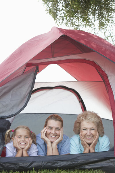 Grandmother, Daughter And Granddaughter Smiling From Tent
