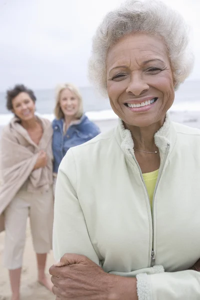 Senior Woman Stands In Fleece Jacket With Friends On Beach — Stock Photo, Image