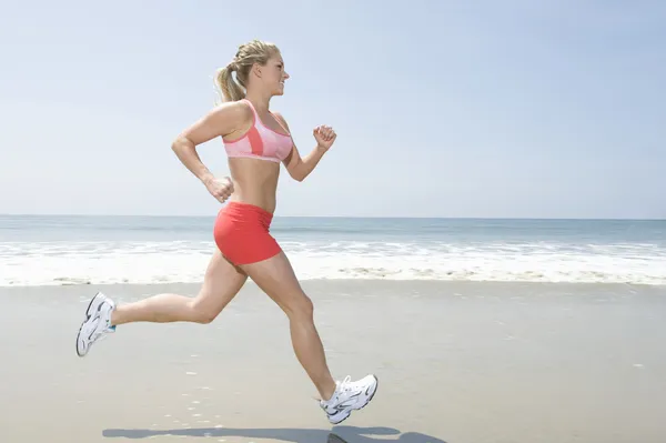 Kobieta joggingu na plaży — Zdjęcie stockowe